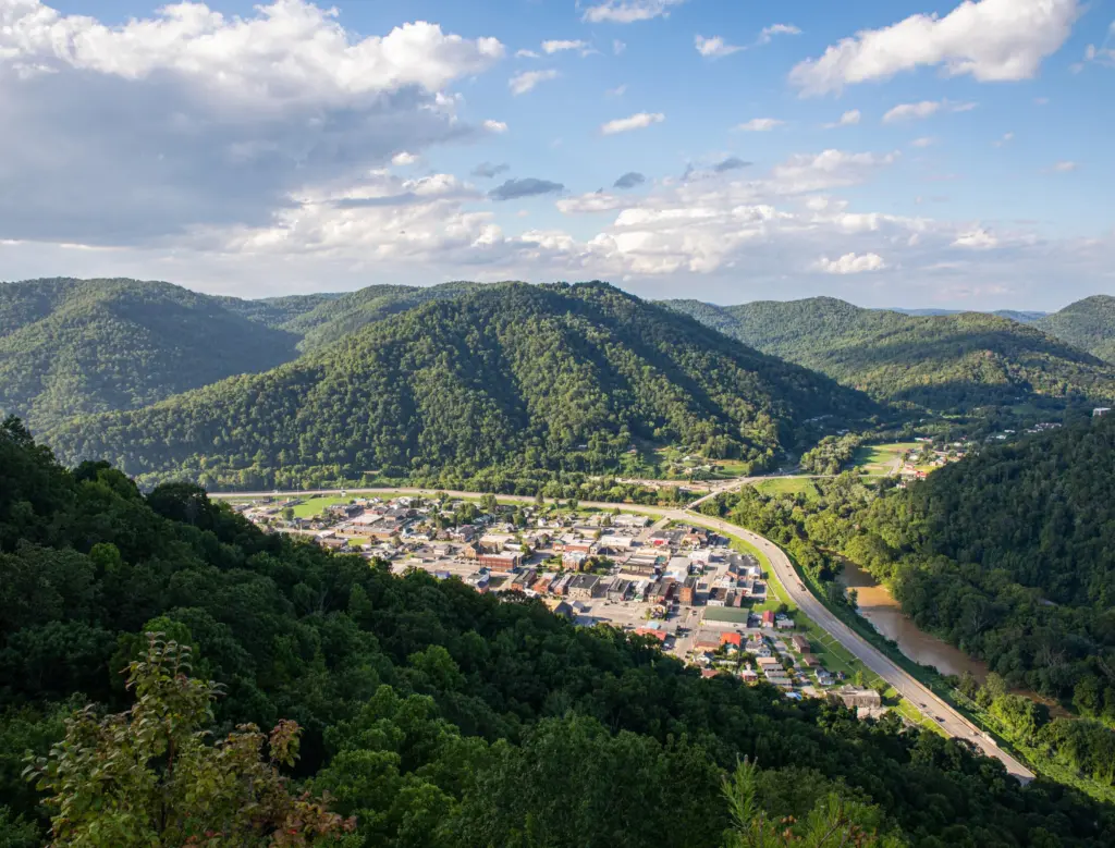 A small Eastern Kentucky town in a river valley among green, rolling mountains.